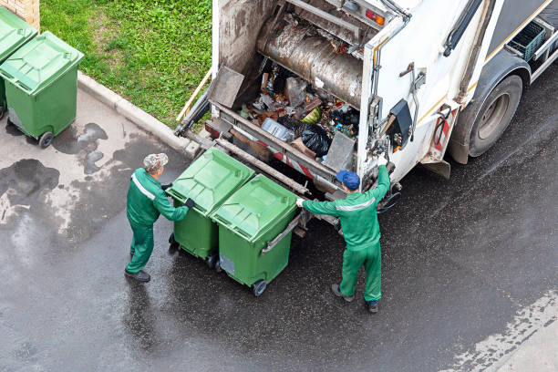 Waste collection crew loading bins into a refuse vehicle
